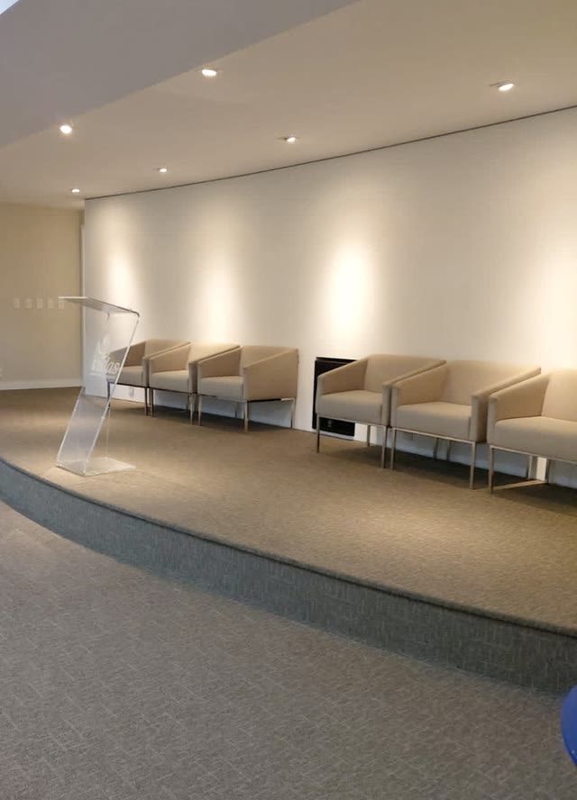 Palco com poltronas estilo sofá para a mesa de honra.